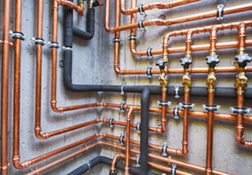 Complex commercial plumbing setup with copper piping
